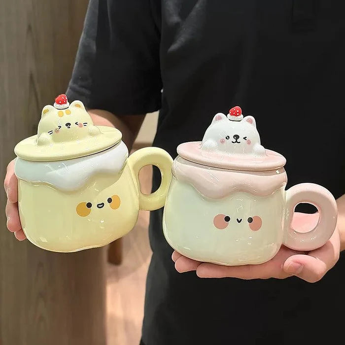 Two ceramic animal pudding mugs held up: yellow cat and white cat with strawberry lid