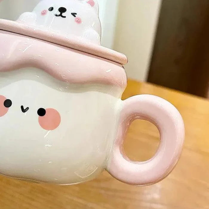 Ceramic cat pudding mug close-up: white body, pink handle, and cat face detail