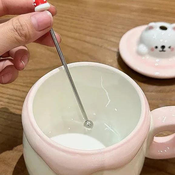 Ceramic cat pudding mug opening with spoon over the smooth white interior