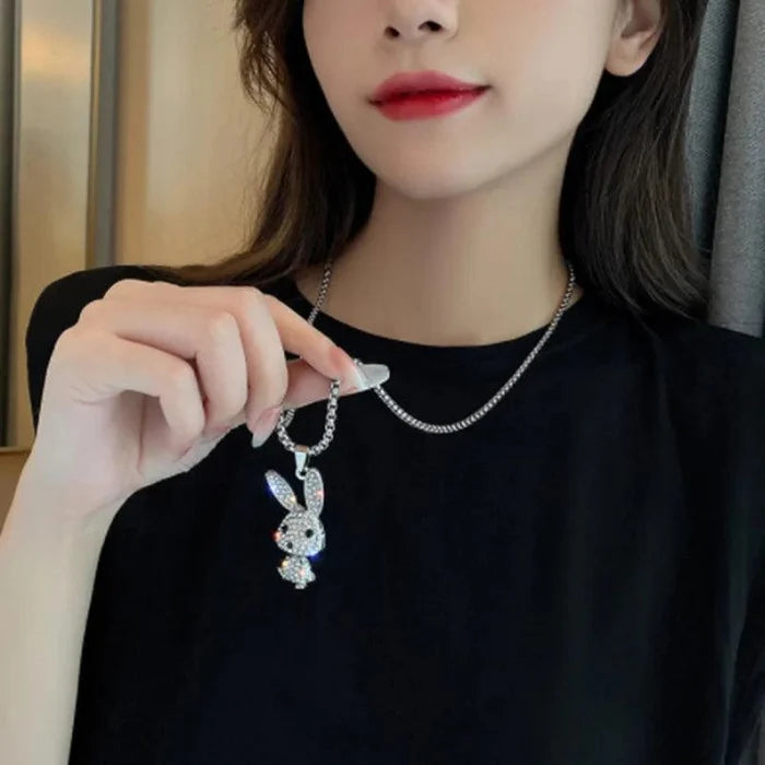 Rhinestone bunny pendant necklace worn on a black top with silver-tone chain