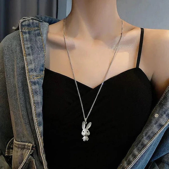 Rhinestone bunny pendant necklace worn at chest level with thin silver-tone chain