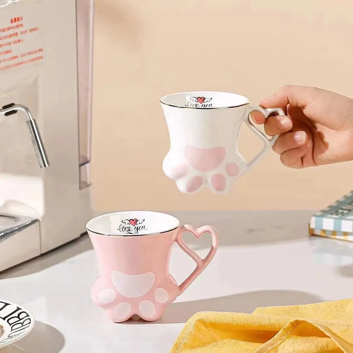 Pink cat paw mug with heart-shaped handle and white paw pad design