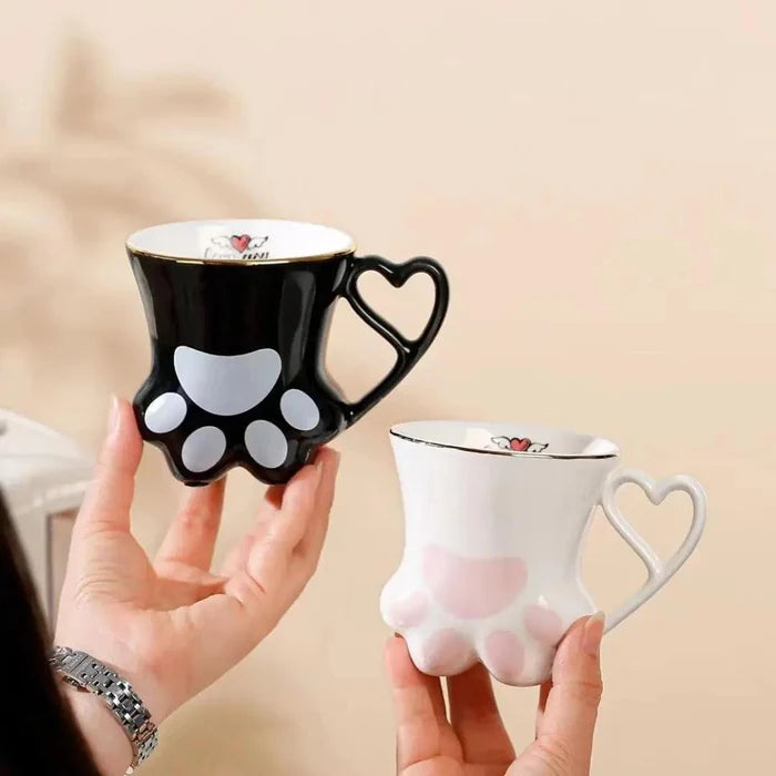 Black and white cat paw mugs with heart handles and paw pad designs