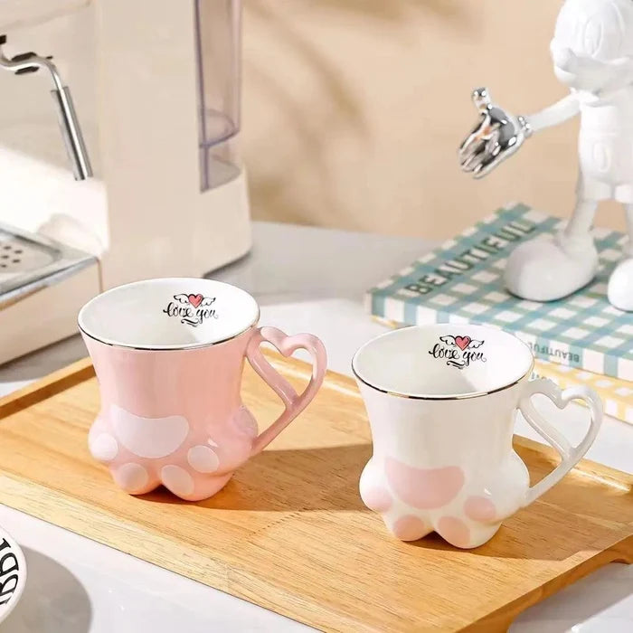 Pink and white cat paw mugs with heart handles and paw pad design