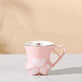 Pink cat paw mug with heart handle and white paw pad accents