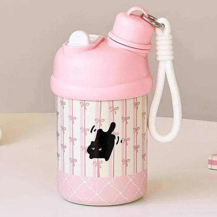 Pink thermos bottle with black cat on bow-and-stripe panel, carry handle