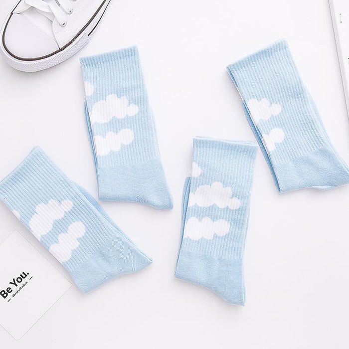 Light blue crew socks with three white cloud prints and ribbed cuffs
