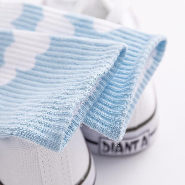 Light blue ribbed socks with white cloud pattern, close-up fabric texture