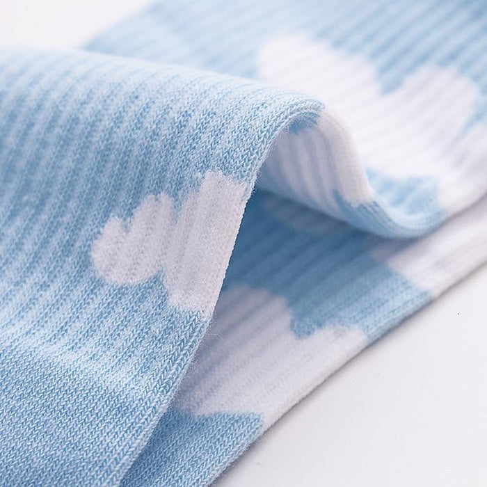 Light blue sock leg with white cloud print, smooth knit and ribbed cuff edge