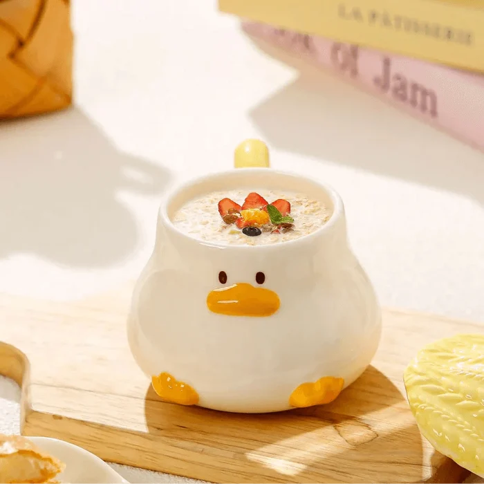 Duck-shaped ceramic mug with duck-face front and open top filled with food