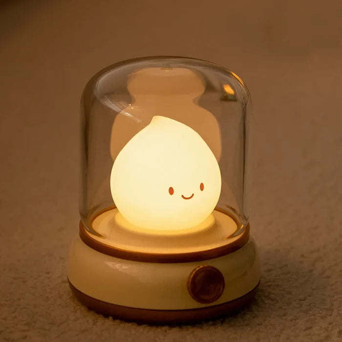 Green flame night light with smiling teardrop bulb in clear glass dome