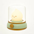 Green flame night light with glowing smiling teardrop bulb under white dome