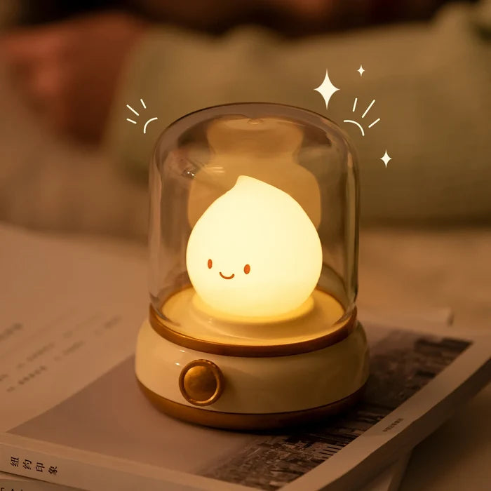Green flame night light with glowing smiling teardrop bulb in clear glass dome