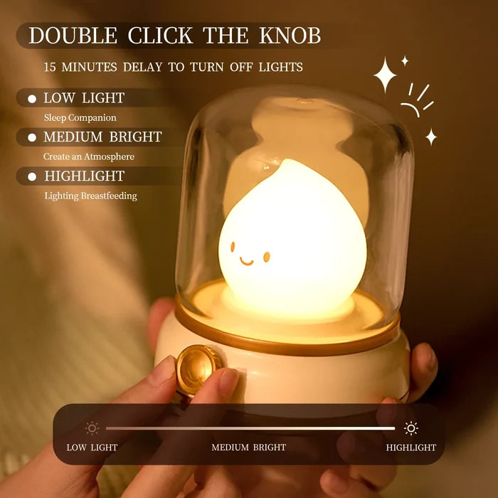 Green flame night light with glowing smiling teardrop bulb in clear glass dome