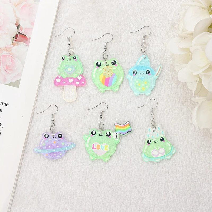 Green frog face acrylic dangle earrings with pastel pink skirt and heart detail