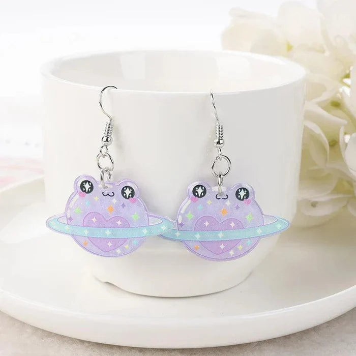 Purple frog face acrylic dangle earrings with star accents and kawaii faces