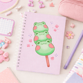 Square spiral notebook with pale purple grid cover and green frog dango graphic