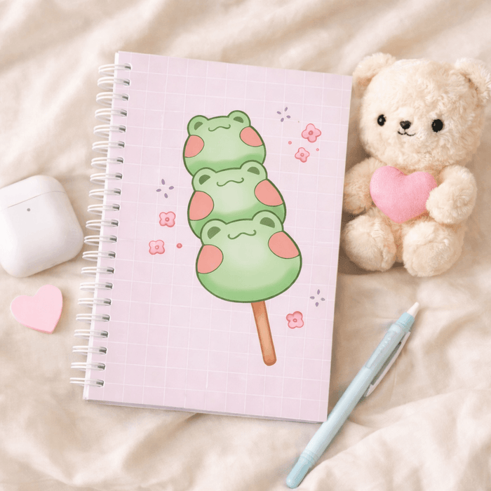 Square spiral notebook with lilac grid cover and green frog dango illustration