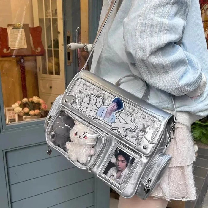 Silver ita shoulder bag with star applique, clear pockets, and crossbody strap