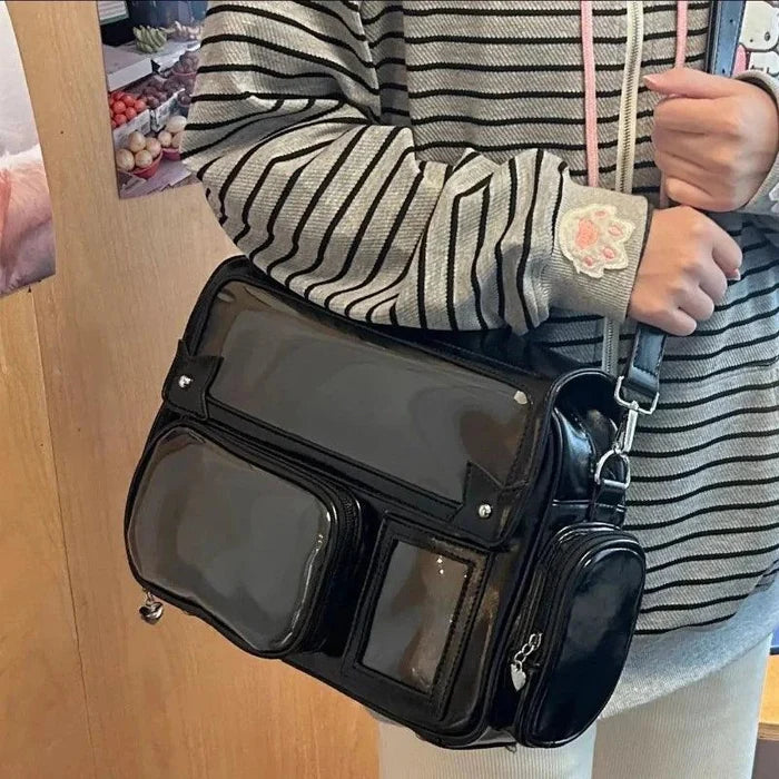 Black ita shoulder bag with clear front pockets and chunky crossbody strap hardware