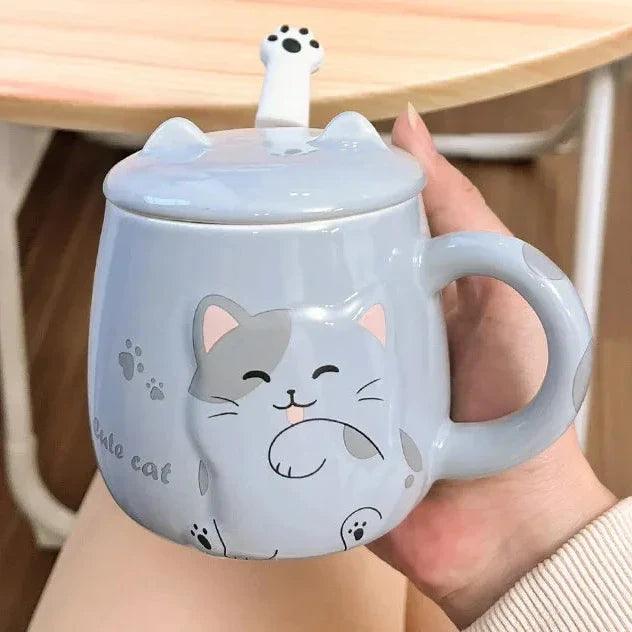 Light blue cat face lidded mug held in a hand