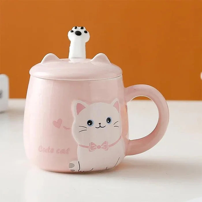 Pink cat face lidded mug with bow, standing on a flat surface