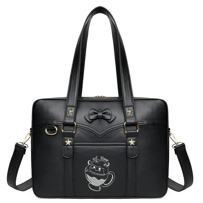 Black messenger bag with bow front, gold-tone star accents, top handles, and shoulder straps