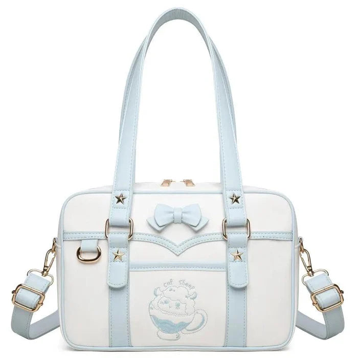 Light blue and white messenger bag with bow front, star accents, and crossbody straps