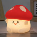 Mushroom night light with red cap and smiling white face, warm glowing light