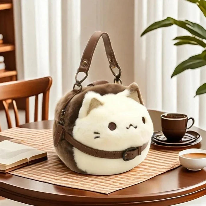 Brown and cream cat plush crossbody handbag with top handle and stitched strap details.