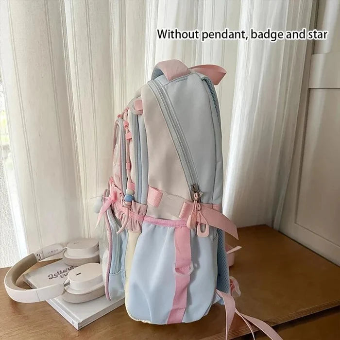 Pastel backpack back panel with light blue fabric and pink strap ties.