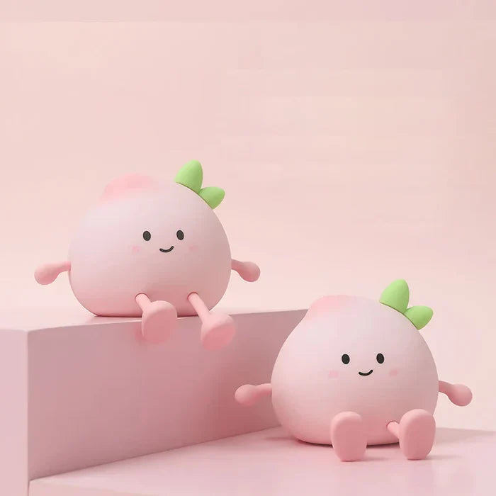 Peach-shaped night lights with smiling faces and green sprout, glowing on a shelf