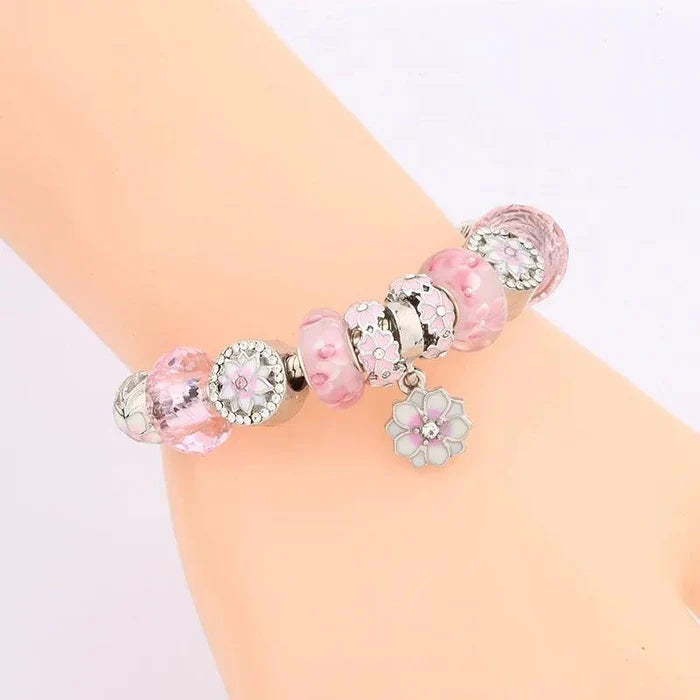 Pink and clear bead charm bracelet with flower charm and heart-shaped pendant detail