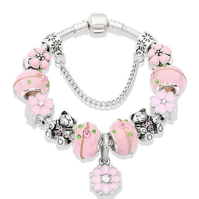 Silver-tone charm bracelet with pink bead clusters and flower charms with a hanging flower