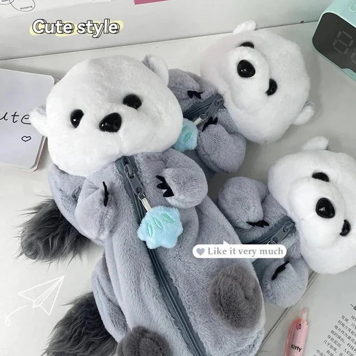 Plush otter pencil case in gray with white face, zipper pocket, and blue flower detail
