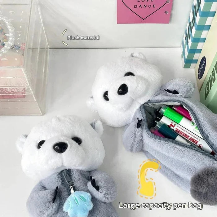 Plush otter pencil case with open zipper, showing colored pens inside and white face