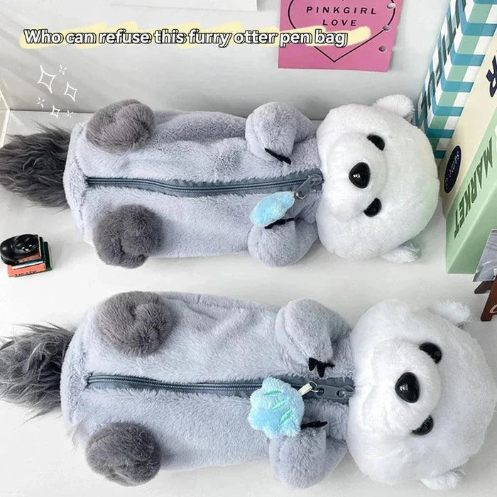 Gray plush otter pencil case with white head, long zipper, and blue flower decoration