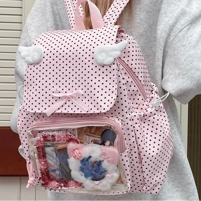 Pink polka dot backpack with double front pocket, bunny-ear straps, and ribbon bow