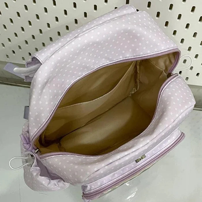 Lilac polka dot backpack interior view with gold lining and zippered compartment