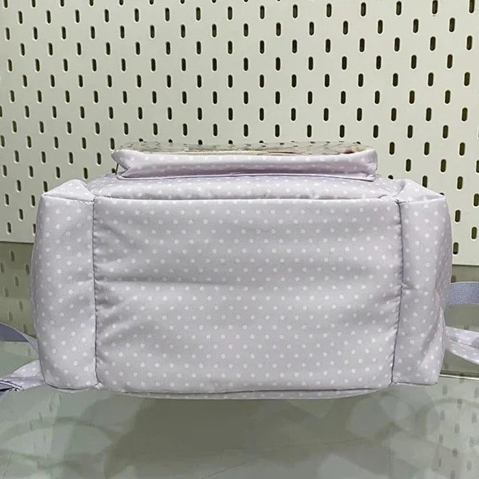 Lilac polka dot padded back panel backpack with top handle and zip closure
