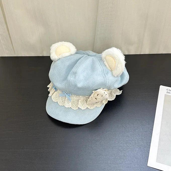 Light blue bear-ear cap with scalloped lace trim and soft plush animal-ear details