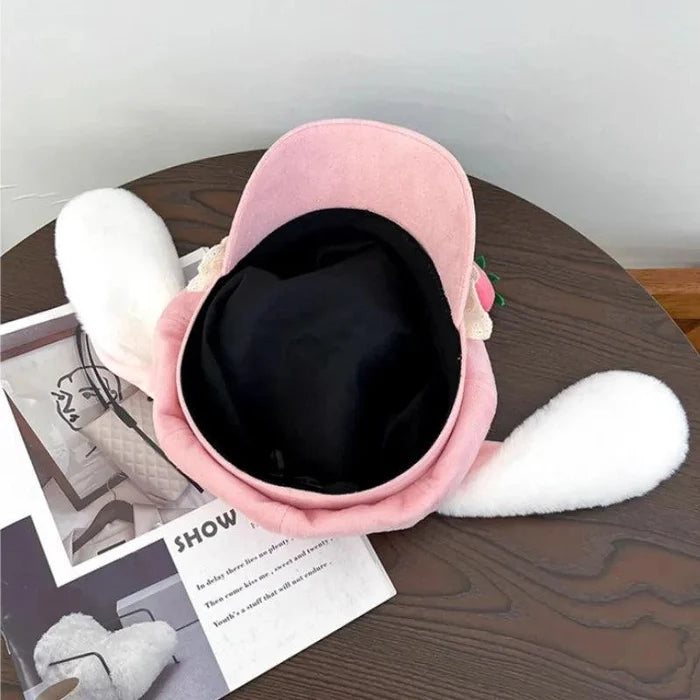 Pink strawberry bunny hat viewed from inside with soft lining and white ear flaps