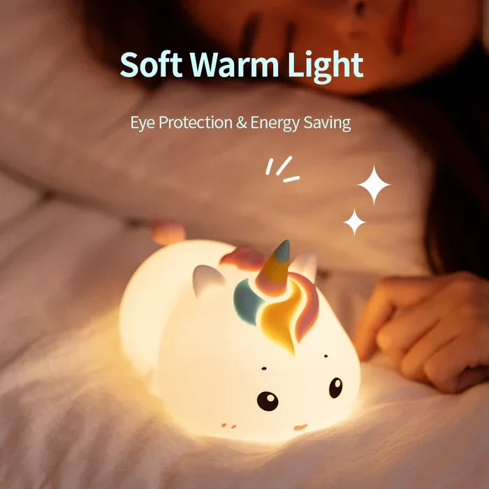 White unicorn night light on a surface, warm glow from horn