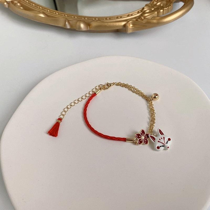 Fox bracelet with gold chain, red cord, flower charm and fox face pendant