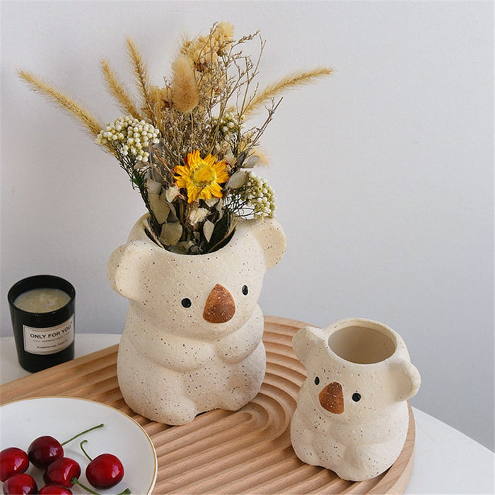 Speckled beige koala planter pot and smaller pot with dried flowers