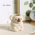 Speckled beige koala planter pot with brown nose and open plant bowl