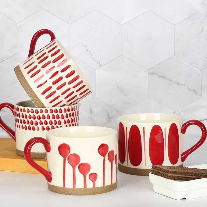Hand-painted ceramic mugs set with red designs, white bodies, and red handles
