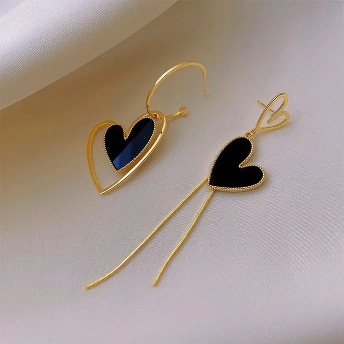 Black heart dangle earrings with gold-tone heart outlines and long drop threads.