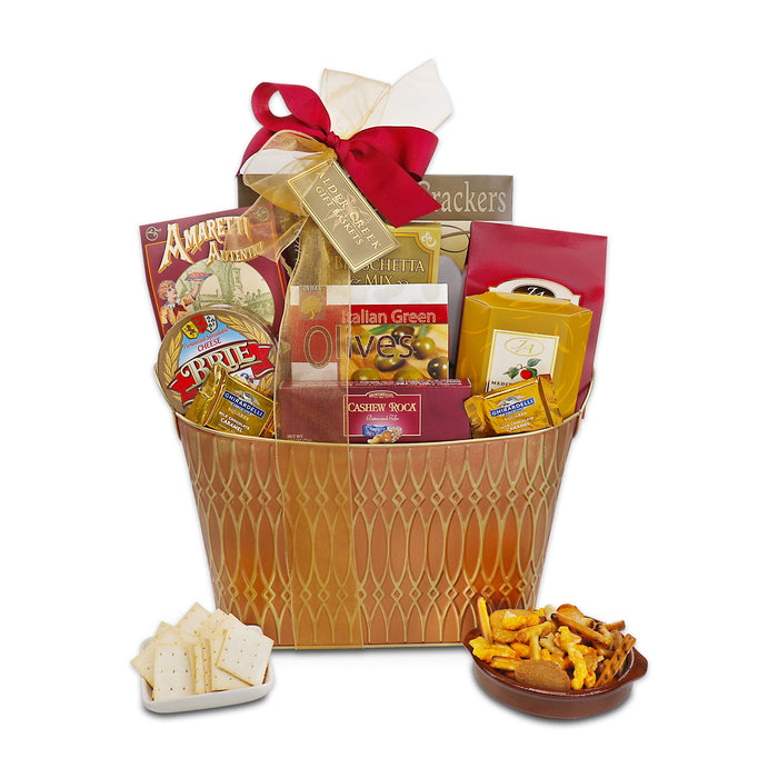 Gift basket in gold wicker filled with crackers, cheese, olives, and snacks; red bow