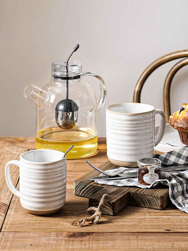 Arctic white ribbed ceramic mugs with handles on a wooden table